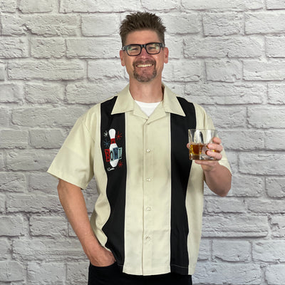 This loose, comfortable, and airy "Lucky Strike" PopCheck Double Panel Bowling Shirt in Stone/Black is great for all you cool cats and bowling lovers out there! It features an embroidered, retro styled, bowling pin on a single black panel on a stone polyester shirt.  